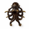 Close up of a brass octopus wall hook in a dark aged patina finish