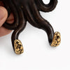 Close up of brass octopus wall hook tentacles in a dark aged patina finish