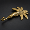 Angled side view of brass palm tree wall hook on dark background showing hook curve depth and palm trunk detail – banana tree brass hook polished gold – palm tree coat hook towel hook key hook – tropical boho beach coastal home decor – handcrafted solid brass Bali