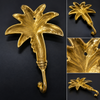 Brass palm tree wall hook multi-angle collage on dark background showing front side and detail views of banana palm tree sculpture and hook – palm tree coat hook key hook towel hook – tropical boho beach house coastal home decor – handcrafted solid brass Bali UbudGlassandBrass