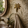 Brass palm tree wall hook mounted in tropical boho bathroom holding linen towel beside round mirror with botanical wallpaper vintage faucet and plants – banana tree brass hook coat hook key hook – beach house coastal tropical home decor – handcrafted solid brass made in Bali by UbudGlassandBrass