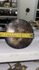 Close-up measurement of brass door pull backplate base size for mounting and hardware fit.
