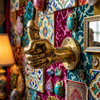 Brass penis hand wall hook mounted on vibrant colorful moroccan tile wall with ornate frame and lamp – maximalist quirky after dark kinky decor – funny adult home decor – man cave bachelorette housewarming gift – polished gold brass hand-cast – handcrafted in Bali