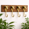 Set of 4 brass ram head wall hooks mounted on wooden backboard, gothic dark academia wall decor