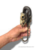 Brass ram skull wall hook held in hand for scale, heavy-duty wall hanger for coats, bags, towels, or jewelry