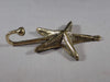 Side profile of brass sea star hook showing depth and wall projection