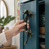 Brass seahorse door pull installed on blue door, nautical front door hardware