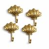 Set of four gold brass seashell wall hooks for coastal bathroom or beach house decor