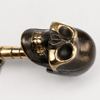 Close-up of solid brass skull hook head in dark antique finish showing detailed hand-cast skull face hollow eye sockets jaw and cranium — gothic dark academia skull hook handmade in Bali