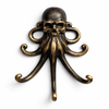 Close up of a brass skull-octopus wall hook in a dark aged patina finish