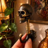 Hand holding solid brass skull hook in dark antique finish close-up showing detailed skull face and spine — gothic dark academia skull coat hook handmade in Bali