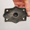 Close-up of solid brass skull wall hook mounting backplate in dark antique finish showing screw holes and plate detail — gothic skull hook hardware handmade in Ubud Bali