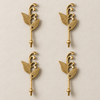 Set of four brass sprout leaf hooks in a polished gold finish arranged in a grid on a cream background