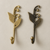 Two brass sprout leaf hooks side by side showing polished brass and patina brass finish options