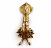 Close up of a brass squid wall hook in a polished gold finish