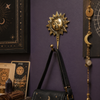 Brass sun face wall hook styled in dark celestial room with moon decor and tarot art – decorative boho wall hook