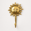 Polished gold brass sun wall hook on white background – included in celestial brass wall hook set of 3 – handcrafted sunburst sun face design 6 inch tall 4 inch wide – boho celestial witchy entryway key hook jewelry holder – astrology home decor gift – solid brass made in Bali