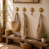 Set of 4 brass sun wall hooks in boho entryway with woven bags and linen hanging above wooden bench – entryway gallery wall hook set