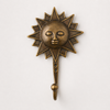 Single antique brass sun face wall hook front view on white background – dark patina finish one of four hooks in handcrafted set