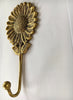 Gold bronze finish sunflower wall hook close-up, vintage floral hardware for farmhouse decor