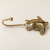 Side view of a brass sea turtle wall hook showing the curved hook shape, part of the ocean animal coastal hook set.