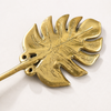 Back view of brass monstera leaf wall hook showing mounting detail and solid construction