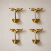 Single solid brass whale tail wall hook centered on a neutral background. Minimal coastal decor wall hook for bathroom towels, entryway keys, or coat hanging
