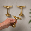 Set of brass whale tail wall hooks styled on wall, coastal decor hooks for towels coats and entryway