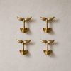 Brass whale tail wall hook set displayed on a wall in a home decor setting. Coastal nautical hooks for bathroom, entryway, and beach house organization.