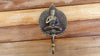 Angle view of brass Buddha wall hook showing functional design for bathroom or meditation decor