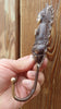 Hand holding Buddha wall hook close-up showing detailed sitting Buddha craftsmanship