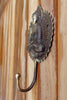 Side profile of brass Buddha wall hook showing hook curve for towels or robes