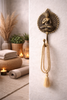 Brass Buddha wall hook used in zen bathroom decor with towel hanging spa style interior