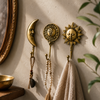 Set of 3 celestial brass wall hooks styled near round mirror holding keys beaded necklace and linen scarf – sun hook sun moon face hook and crescent moon hook in polished gold – boho celestial entryway key hook jewelry holder – witchy astrology home decor – handcrafted in Bali