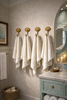 Clam shell wall hook set styled in a beach house bathroom for towel storage and coastal decor