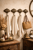 Multiple brass shell wall hooks installed in luxury coastal bathroom