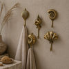 Brass coastal wall hooks set styled in bathroom beach house decor