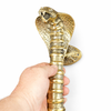 Hand holding cobra door handle front view, solid brass serpent entry door pull hardware
