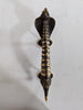 Mounted cobra door handle on wall showing installation brackets brass hardware