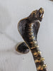 Real photo of single cobra door handle, solid brass snake entry door pull with vintage patina