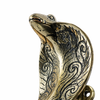 Solid brass cobra door handle shown in hand for scale demonstrating size and weight of snake door pull