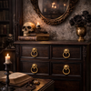 Dark academia dresser styled with skull ring pulls and moody lighting, gothic cabinet hardware inspiration