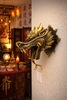 Brass dragon head wall decor styled in Chinese-inspired room with warm lantern lighting