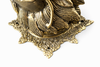 Close-up of brass dragon head wall sculpture base detail and textured edge