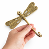 Dragonfly brass wall hook held in hand for size reference, strong hook for coats, bags and towels