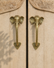 Matching brass elephant trunk door handle set mounted on double French doors, handcrafted antique brass hardware for entry door handle set, boho entryway decor and global home decor