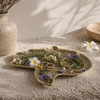Fatima hand brass tray styled on coffee table with natural decor, used as a tobacco tray, spiritual decor tray, and boho brass tray accent