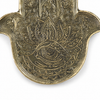 Macro detail of Fatima hand eye engraving on brass rolling tray, Hamsa tray symbol representing protection and spiritual energy
