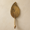 Gold brass leaf wall hook front view, hand-cast spade-shaped hook with natural leaf vein detail