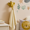 Kids room with brass elephant wall hooks used for hanging clothes